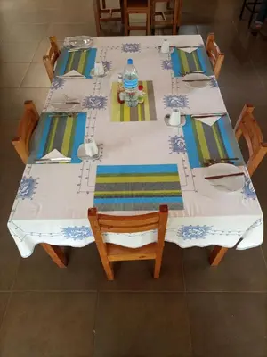 a white table with chairs and a bottle of water on it at STC.SAFARI LODGE in Oldeani