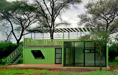 a green house with a staircase on top of it at Elephant lodge in Kwa Kuchinia
