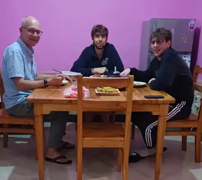 a group of three men sitting at a table at BABA AFRICA HOSTEL in Arusha