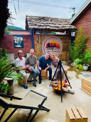 a group of people sitting in front of a fire at Swahili Villa in Arusha
