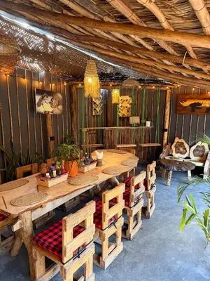 a dining room with a wooden table and chairs at Swahili Villa in Arusha