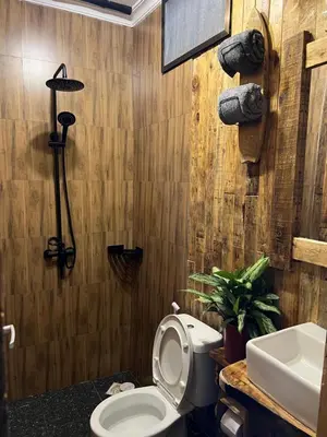 a bathroom with a toilet and a sink at Swahili Villa in Arusha