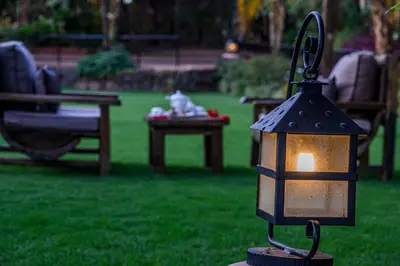 a lighted lamp on a table in a yard at KUDU LODGE & CAMPSITE in Karatu