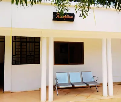 two blue chairs sitting outside of a building at Hellen's Riverside villas in Moshi