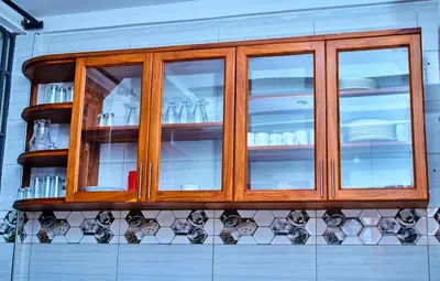 a wooden cabinet with plates and dishes in it at Aves Executive Hotel in Arusha