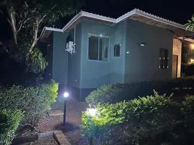 a house at night with lights in front of it at Maro Homestay Sango in Old Moshi