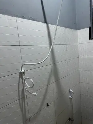 a hose is on a wall in a bathroom at Maro Homestay Sango in Old Moshi