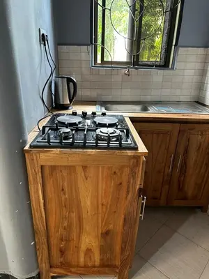 a stove top in a kitchen with a counter at Maro Homestay Sango in Old Moshi