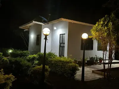 two lights in front of a house at night at Maro Homestay Sango in Old Moshi