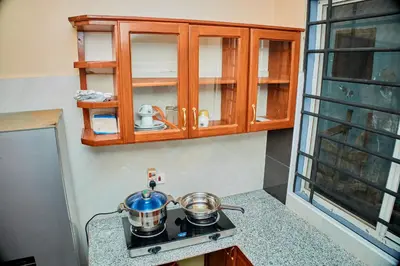 a kitchen with two pots and pans on a stove at Arusha Serene Apartments in Arusha
