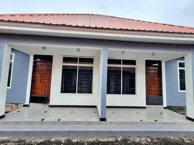 a building with four windows on a wooden deck at Arusha Serene Apartments in Arusha
