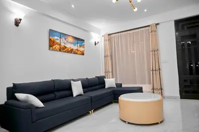 a living room with a blue couch and a coffee table at Diamond Apartments in Arusha