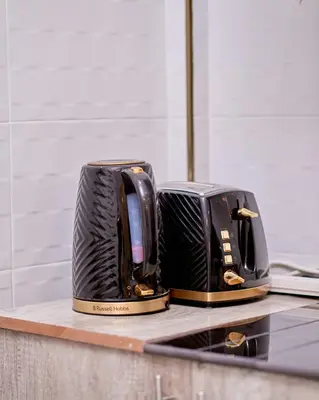 two toasters sitting on top of a kitchen counter at Diamond Apartments in Arusha