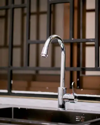 a sink with a faucet in a bathroom at Diamond Apartments in Arusha