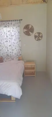 a bedroom with a bed and two umbrellas on the wall at Unique Heritage in Arusha