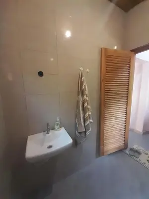 a bathroom with a white sink and a shower at Unique Heritage in Arusha