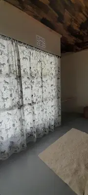 a bedroom with a curtain with animals on it at Unique Heritage in Arusha