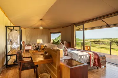 a master bedroom with a bed and a desk and a desk at Salinero Serengeti in Ututwa
