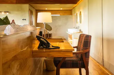 a room with a wooden desk with a telephone on it at Salinero Serengeti in Ututwa