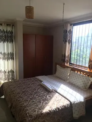 a bedroom with a large bed and a window at maasaifari runako in Ilboru