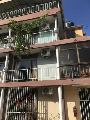 an apartment building with balconies and windows at maasaifari runako in Ilboru