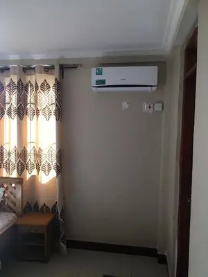 a room with a door with a curtain and a window at maasaifari runako in Ilboru