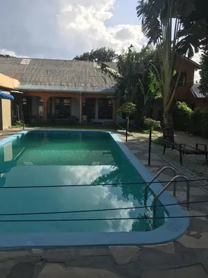a swimming pool in front of a house at maasaifari runako in Ilboru