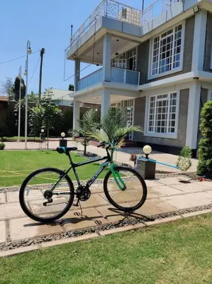 a bike parked in front of a building at Luxury 2BR apartment in Usa River