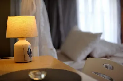 a lamp sitting on a table next to a couch at Luxury 2BR apartment in Usa River
