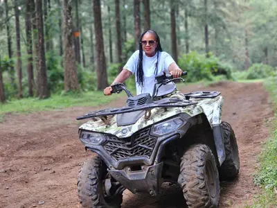 a man riding a four wheeler on a dirt road at Fly Africa Village in Arusha
