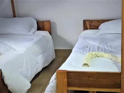 two beds sitting next to each other in a room at Domus Aurea Safaris in Oldeani