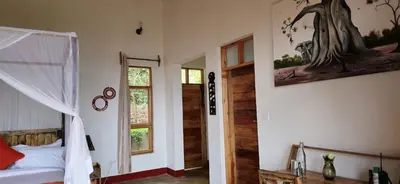 a bedroom with a bed and a window at Mamadunia Safari Lodge in Karatu