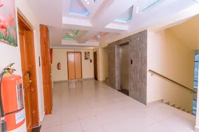 a hallway in a building with a skylight at Selig Hotel in Moshi