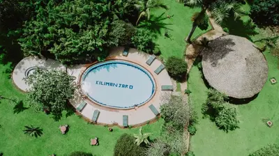 an overhead view of a swimming pool in a park at KILEMAKYARO Mt LODGE in Uru