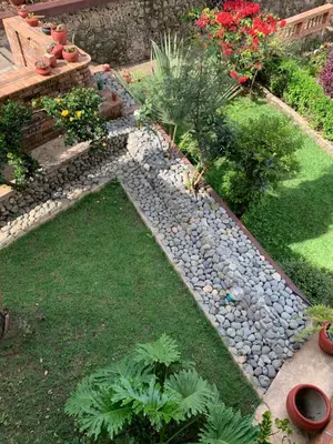 a garden with a stone path and plants and flowers at Peakline Apartments in Arusha