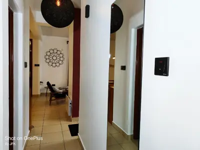 a hallway leading to a living room with a table at Twiga Luxe in Arusha