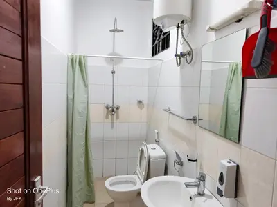 a small bathroom with a toilet and a sink at Twiga Luxe in Arusha