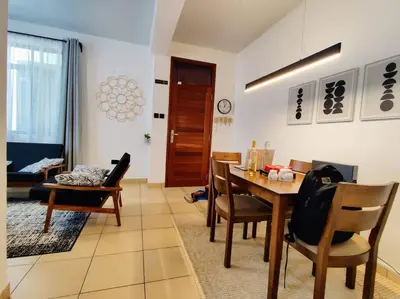 a living room with a dining room table and chairs at Twiga Luxe in Arusha