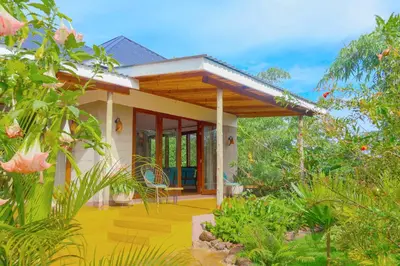 a house in the middle of a garden at Moonbow lodge in Mto wa Mbu