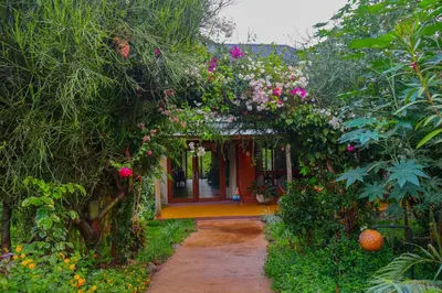 an entrance to a garden with a bunch of flowers at Moonbow lodge in Mto wa Mbu