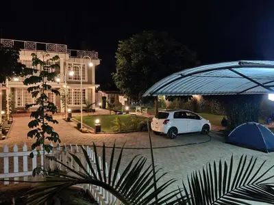a white car parked in a parking lot at night at Romantic Getaway in Arusha