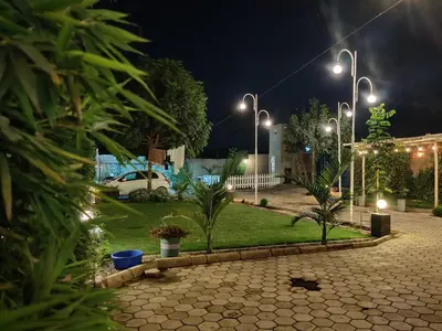a park at night with street lights and plants at Romantic Getaway in Arusha