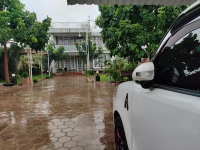 a white car parked in front of a building at Romantic Getaway in Arusha