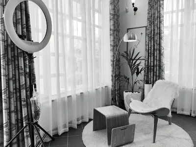 a mirror and a chair in a room with curtains at Romantic Getaway in Arusha