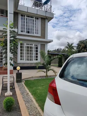 a white car parked in front of a house at Romantic Getaway in Arusha