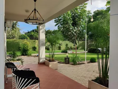a patio with a view of a garden at Romantic Getaway in Arusha
