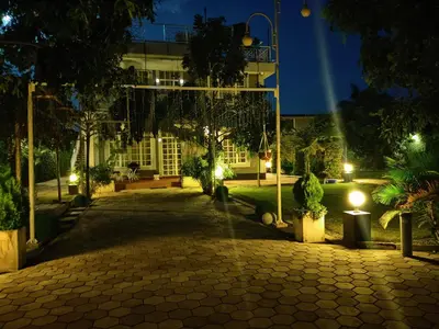 a courtyard of a building at night with lights at Garden View with detached Bathroom in Arusha