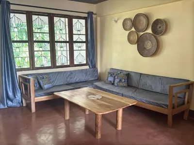 a living room with a couch and a table at Mahali House in Moshi
