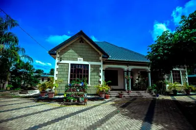 a house with potted plants in front of it at Bed and Stay with Mount Kilimanjaro View in Moshi