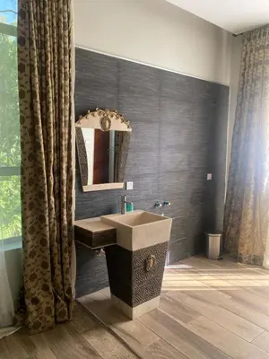 a bathroom with a sink and a mirror at Serene Vacay Hotel Marangu in Marangu
